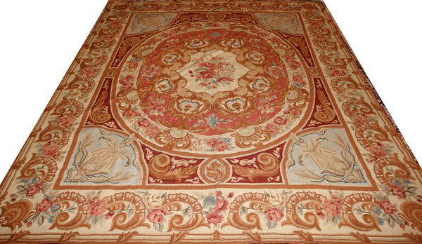 FRENCH STYLE NEEDLEPOINT RUG, 10' 0" X 8' 0": FRENCH STYLE NEEDLEPOINT RUG, 10' 0" X 8' 0":Large floral medallion at the center, scroll motif at the border with pink rose accents. After 1940.