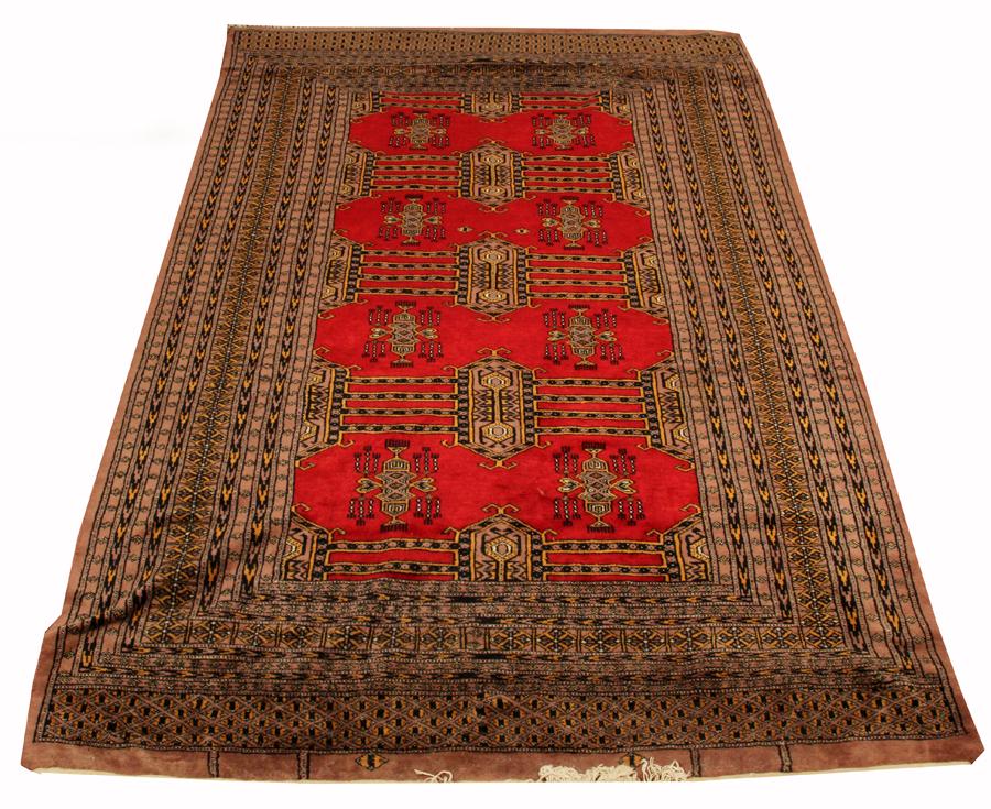 TURKMAN HANDWOVEN WOOL RUG, W 4' 2", L 6' 3": TURKMAN HANDWOVEN WOOL RUG, W 4' 2", L 6' 3" Red ground with geometric designs throughout the field, nine borders with an additional wide border at the ends. 4'2" x 6'3".