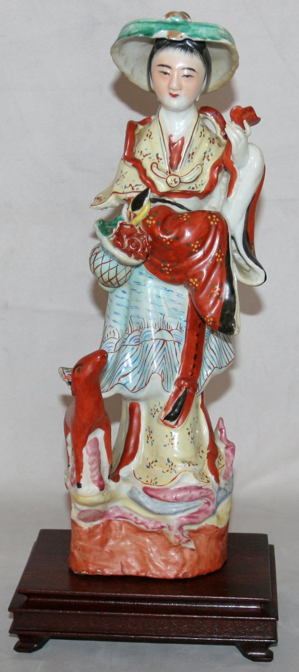 CHINESE PORCELAIN FIGURE OF MAIDEN, H 14": CHINESE PORCELAIN FIGURE OF MAIDEN, H 14", DIA 4":Standing maiden with basket of flowers and a deer. On a wood stand. From the Estate of Robert D. Ellinger, Grand Rapids, MI.