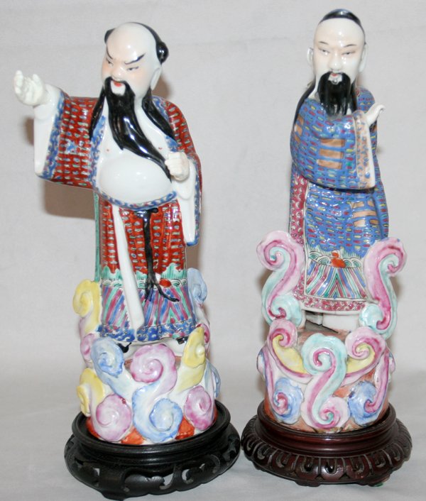 CHINESE PORCELAIN MALE FIGURINES, TWO, H 10": "CHINESE PORCELAIN MALE FIGURINES, TWO, H 10"":standing on integral cylindrical porcelain bases; signature stamp and ""China"" on undersides; On wood stands. From the Estate of Robert D. Ellinger, Gra