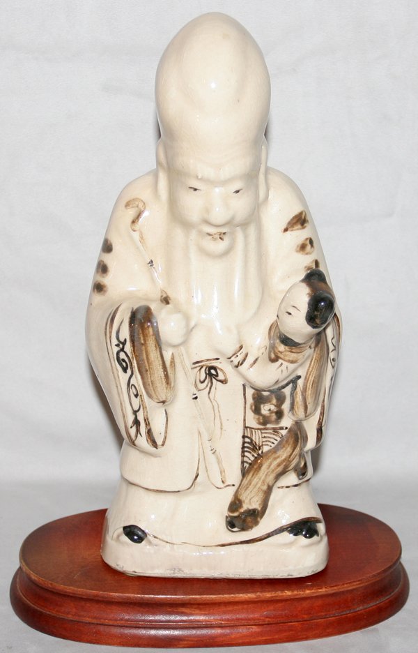 CHINESE POTTERY FIGURE OF WISE MAN AND CHILD: CHINESE POTTERY FIGURE OF A WISE MAN AND CHILD, H 11":depicts man holding child, hand painted, wood stand. From the Estate of Robert D. Ellinger, Grand Rapids, MI.