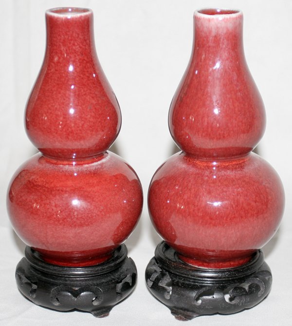 CHINESE SANG DE BOEUF VASES, PAIR, H 5 1/2": CHINESE SANG DE BOEUF VASES, PAIR, H 5 1/2", W 2 1/2":having an oil lamp shape; on wood stands. From the Estate of Robert D. Ellinger, Grand Rapids, MI.