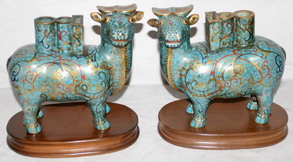 CHINESE CLOISONNÉ CIGARETTE URNS, H 7 1/4": "CHINESE CLOISONNÉ CIGARETTE URNS, PAIR, H 7 1/4"", L 8"":in the form of cattle, match and cigarette urns; designs on blue ground; on wood stands. From the Estate of Robert D. Ellinger, Grand Rapids,