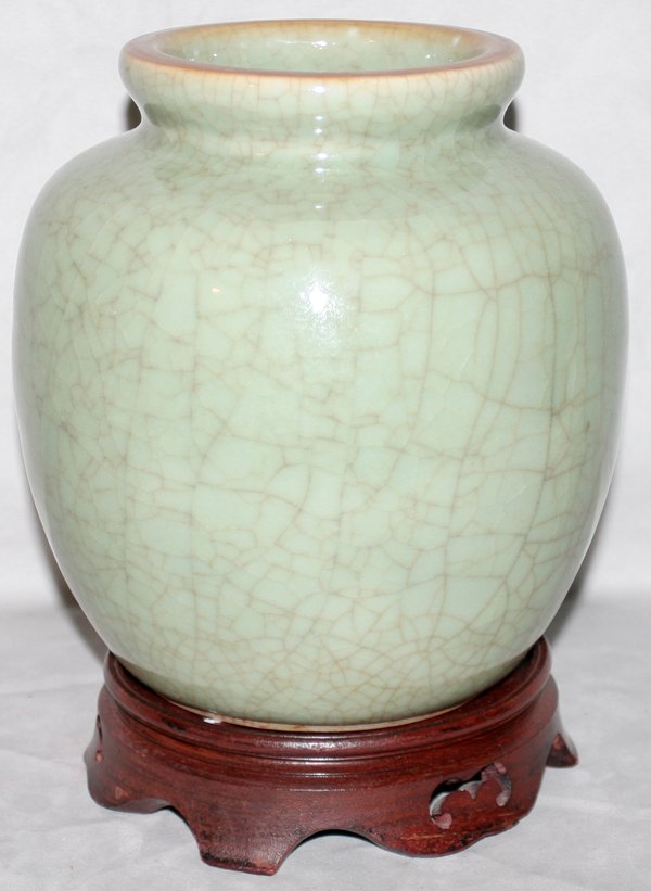CHINESE CELADON VASE, H 8", DIA 8": CHINESE CELADON VASE, H 8", DIA 8":Crackle glaze, light green in color; Drilled on the underside and has a wood stand, as is condition. From the Estate of Robert D. Ellinger, Grand Rapids, MI.