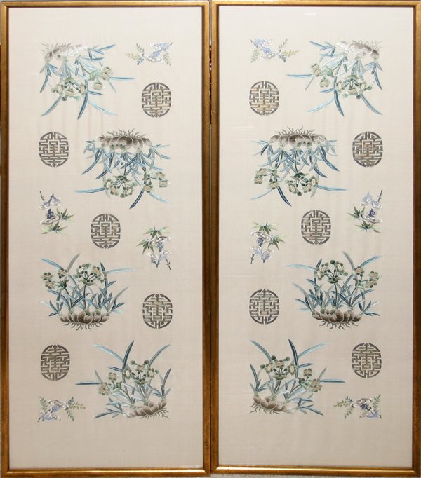 CHINESE SILK EMBROIDERIES, TWO, 35" X 13": CHINESE SILK EMBROIDERIES, TWO, 35" X 13":floral designs with blue leaves and geometric oval shape medallions; framed under glass in gilt wood frames. Late 20th century. From the Estate of Robert D. E