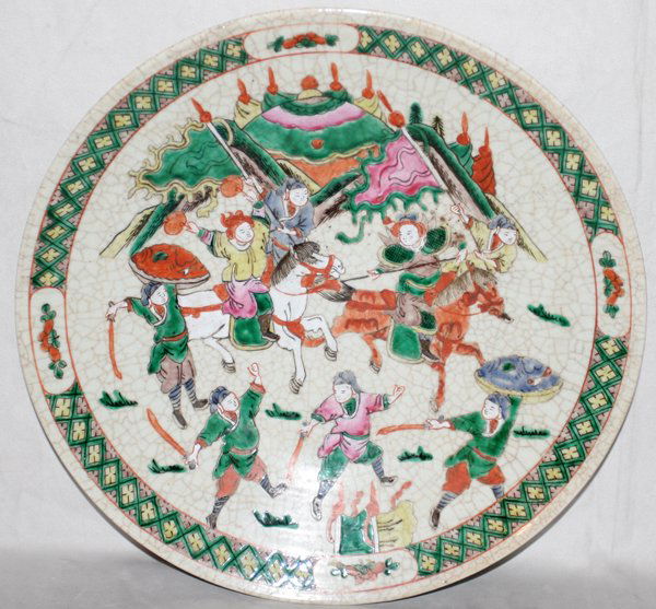 CHINESE PORCELAIN CRACKLE GLAZE CHARGER, H 3": CHINESE PORCELAIN CRACKLE GLAZE CHARGER, H 3", DIA 14":depicting a battle scene. Green cross hatch border; On a wooden stand. From the Estate of Robert D. Ellinger, Grand Rapids, MI.