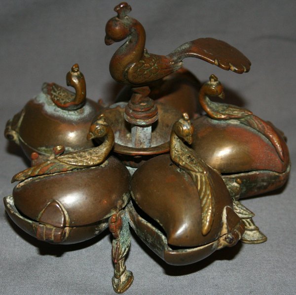 BRASS INCENSE BURNER, H 4", DIA 5": BRASS INCENSE BURNER, H 4", DIA 5":possibly East Indian; having separate hinged compartments each with a peacock finial and a larger central peacock finial; hoof feet; one finial detaches