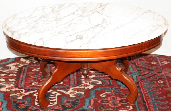 VICTORIAN STYLE COFFEE TABLE WITH MARBLE TOP: VICTORIAN STYLE COFFEE TABLE WITH MARBLE TOP, C. 1940, H 17", W 22", L 34":White beveled marble top. Mahogany base. Grand Rapids, circa 1940. H 17", L 34", D 22".