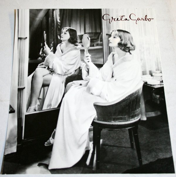 GRETA GARBO AUTOGRAPHED B/W PHOTO, H 10", W 8": GRETA GARBO AUTOGRAPHED B/W PHOTO, H 10", W 8":black and white publicity photo depicting Garbo at her dressing table and signed "Greta Garbo" in black ink, upper right and inscribed "Mata Hari 1932" o