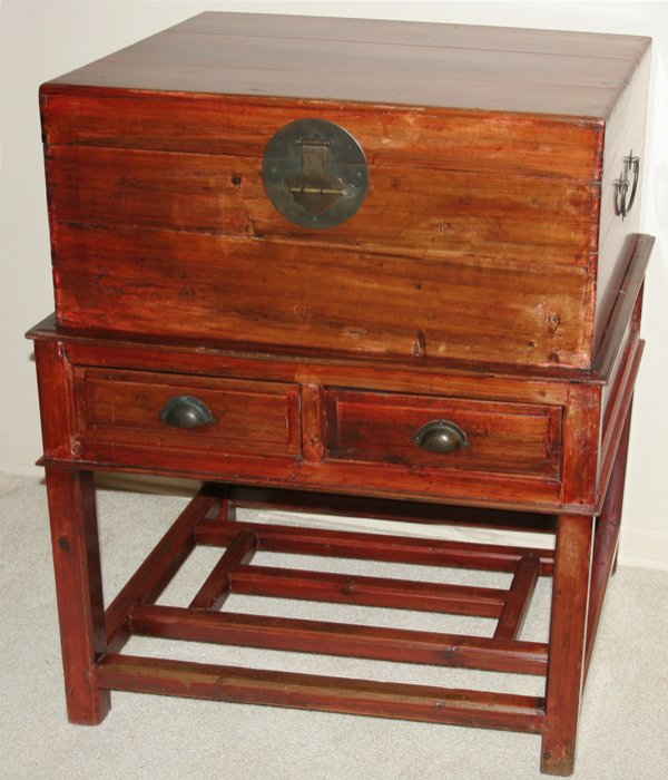 CHINESE CAMPAIGN CHEST ON A STAND, H 36", L 32": CHINESE CAMPAIGN CHEST ON A STAND, H 36", L 32", D 19":Painted red with brass handles and latch; stand has square legs with nine stretchers in parallel and intersecting patterns; From the Estate of Ro