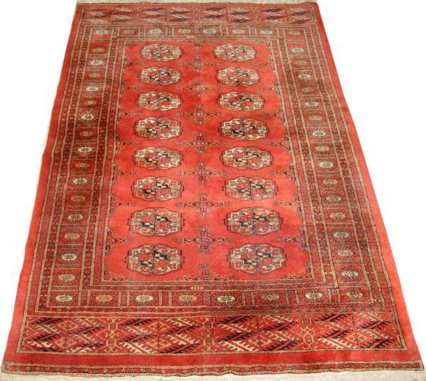BOKHARA ORIENTAL RUG, 6' 2" X 4' 2", HAND-WOVEN: BOKHARA ORIENTAL RUG, 6' 2" X 4' 2", HAND-WOVEN, ALL WOOL:Red brick color ground with 16 white with black octagons. Thick pile. Circa 1960. From the Estate of Robert Wilkins.