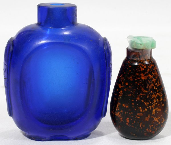 CHINESE BLACK & BLUE GLASS SNUFF BOTTLES, TWO: CHINESE BLACK & BLUE GLASS SNUFF BOTTLES, TWO, H 2" & 2 3/4":Including 1 black glass snuff bottle with gold flecks and jade cap, H.2 1/8", and 1 cobalt blue glass snuff bottle flanked by incised mask