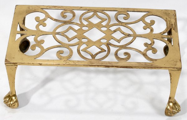 ENGLISH BRASS PIERCED TRIVET, H 4", L 10": ENGLISH BRASS PIERCED TRIVET, H 4", L 10":Rectangular pierced top raised on four legs ending in paw feet, 19th century, overall H.3 7/8" x 11" x 6 1/2".