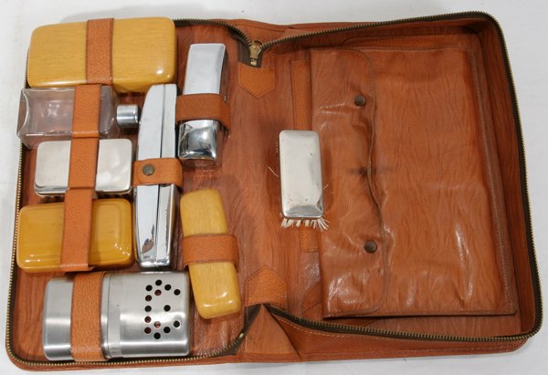 BAKELITE, CELLULOID HAND BEVELED MIRRORS BOXES: BAKELITE, CELLULOID HAND BEVELED MIRRORS BOXES, BRUSHES LEATHER TRAVELING CASE, 18 TOTAL:In case two mirrors, four boxes, scissors, two brushes cologne bottle, hand warmer Aladdin pat#1960.