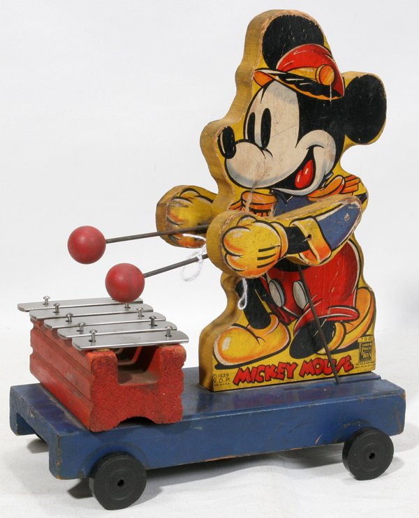 MICKEY MOUSE WOOD AND METAL PULL TOY, C1940: MICKEY MOUSE WOOD AND METAL PULL TOY, C1940, W 5", H 11", L 9":Fisher Price Toys #798 "Mickey Mouse" pull toy depicting Mickey on a wheeled platform with movable arms playing a xylophone; stamped "C 1