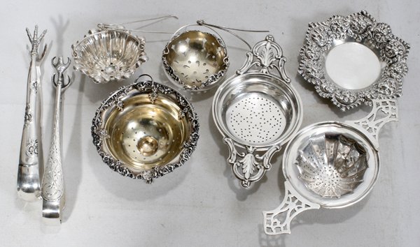 AMERICAN STERLING TEA ACCESSORIES (8)STRAINERS,: AMERICAN STERLING TEA ACCESSORIES (8), LATE 19TH-MID 20TH C., STRAINERS, BASKETS & TONGS:Including 2 tea strainers with pierced handles by Webster Co. (solder repairs to handles of one), 1 Frank M. Wh