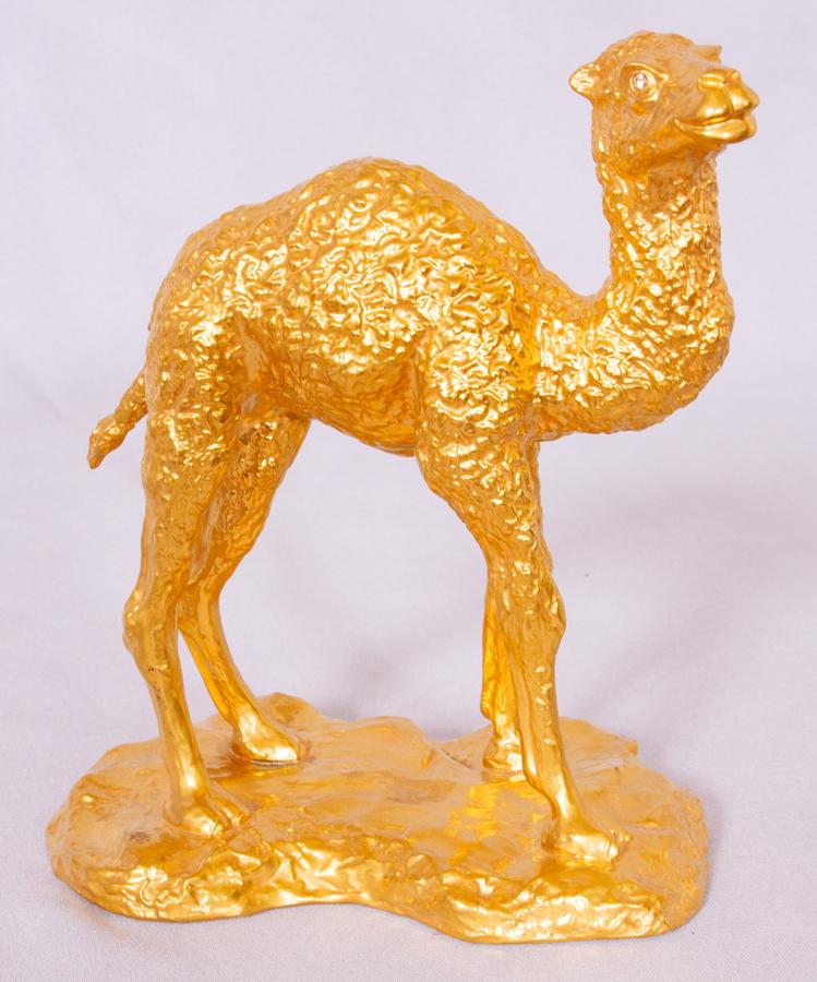 BOEHM GILT PORCELAIN & DIAMOND CAMEL, H 7.5", W 7": BOEHM GILT PORCELAIN & DIAMOND CAMEL, H 7.5", W 7"A limited edition Boehm gilt porcelain camel. Offers two diamond eyes (DIA 1/8" each) and a textured form. Signature branding to the underside.