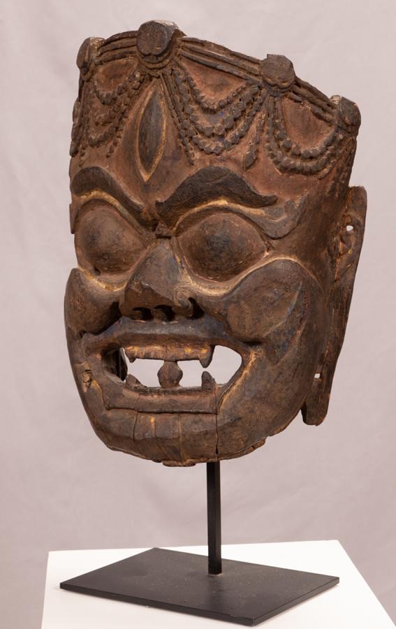 BALINESE CARVED WOOD WITH PIGMENT MASK H 16" W 12" D 6": BALINESE CARVED WOOD WITH PIGMENT MASK H 16" W 12" D 6" On modern metal stand.Provenance: Estate of Jack Faxon, Birmingham, MI. Michigan Senator and creator of the Michigan Council for the Arts.
