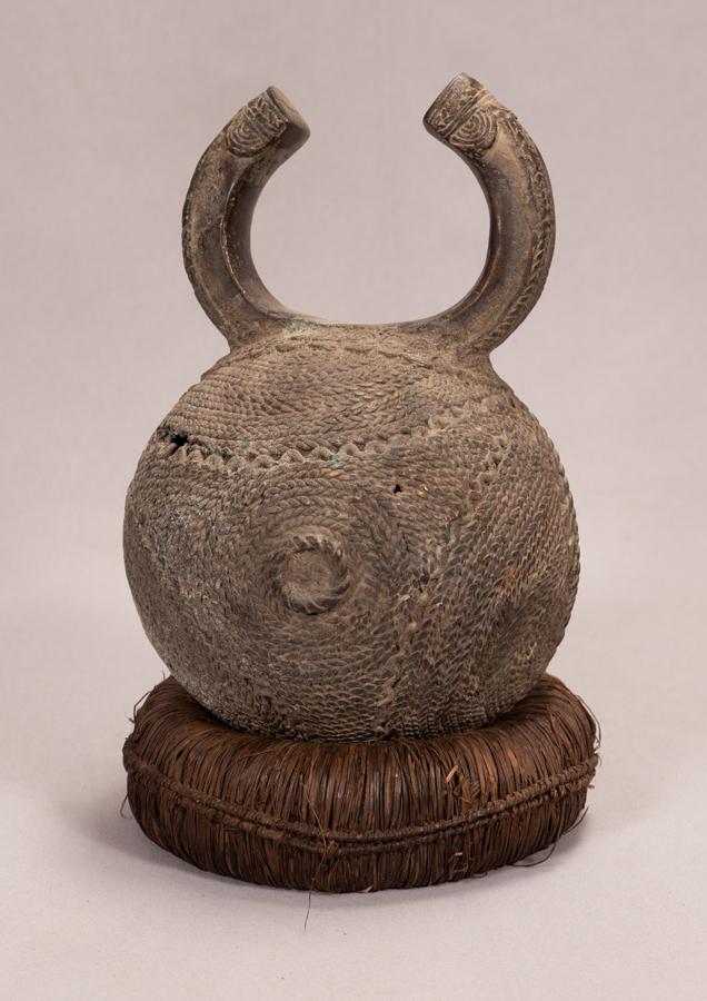 GREBO, LIBERIA, AFRICAN, METAL MONEY H 9.75" DIA 6.25": GREBO, LIBERIA, AFRICAN, METAL MONEY H 9.75" DIA 6.25" along with a non matching wicker ring baseProvenance: Estate of Jack Faxon, Birmingham, MI. Michigan Senator and creator of the Michigan Council 