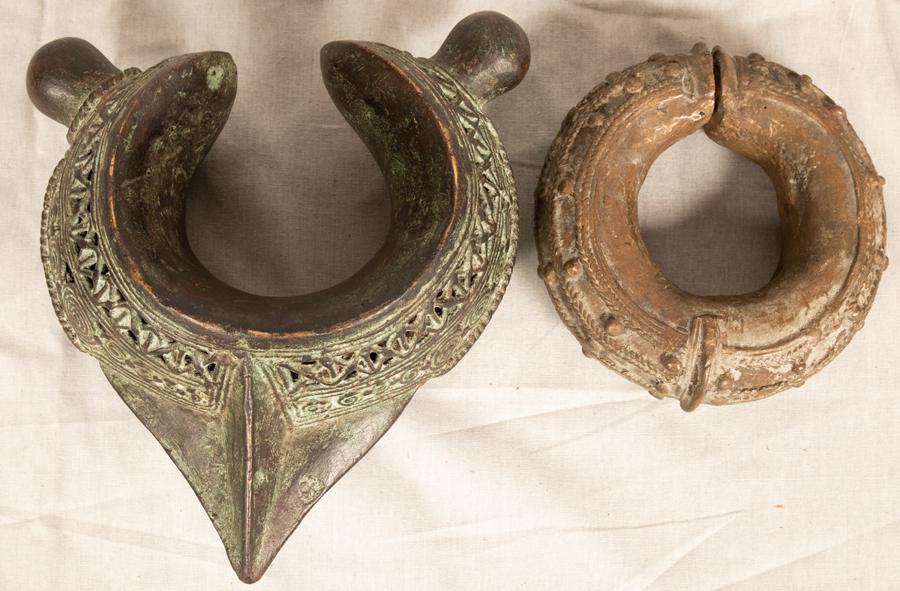 BENIN NIGERIA BRONZE ARM BANDS TWO W 5" - 8": BENIN NIGERIA BRONZE ARM BANDS TWO W 5" - 8" Pierced band with pointed tip and motif of "X's in row. Dia 5.5" W 1.8". Also bronze very heavy armband W 7.2" H 4.5" L 8.7". Provenance: Estate of Jack Fa