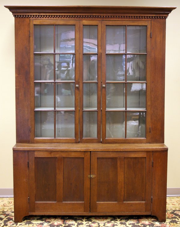 AMERICAN CUPBOARD, C. 1830, H 84", W 59", D 19": AMERICAN CUPBOARD, C. 1830, H 84", W 59", D 19":American country. Having a beveled cornice above dentil molding and two fenestrated doors opening to shelves, a pair of paneled doors at the base. Measu