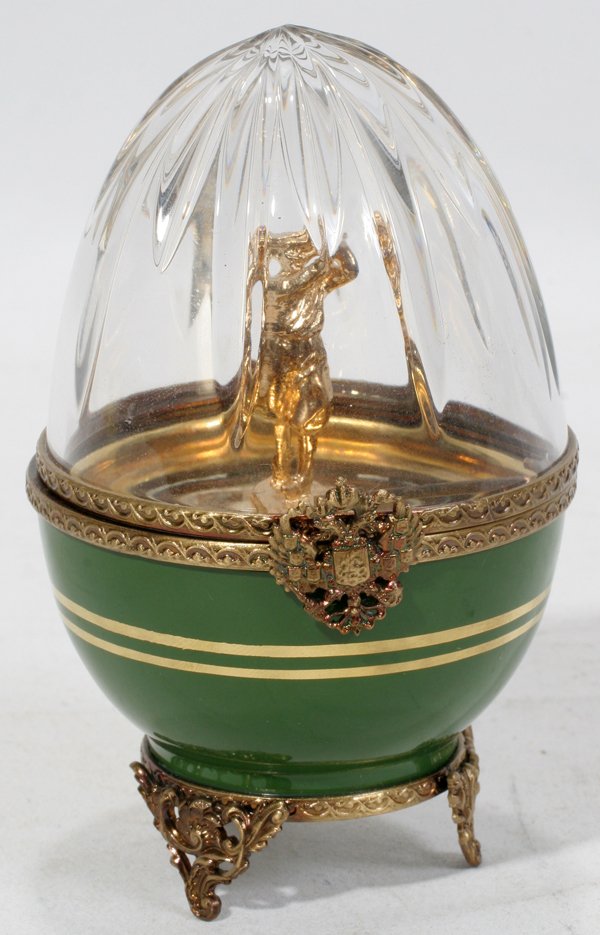 LIMOGES 'FABERGE' CRYSTAL & PORCELAIN BOX, H 4": LIMOGES 'FABERGE' CRYSTAL & PORCELAIN EGG-FORM BOX, H 4":Limited edition Limoges porcelain egg having a crystal top and green porcelain base, gilt metal mounts, hinges open to reveal a golfer and embo
