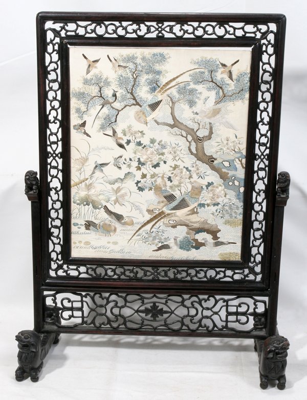 CHINESE EMBROIDERED SILK & TEAKWOOD SCREEN: CHINESE EMBROIDERED SILK & TEAKWOOD SCREEN, EARLY 20TH C., H 24", W 18":A rectangular silk panel embroidered with various exotic birds among foliage, 17" x 14", within a pierced frame and raised on a 