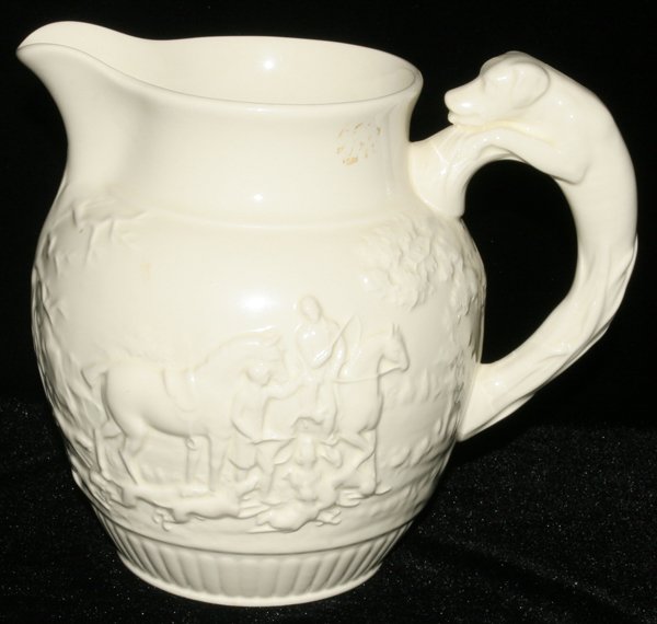 WEDGWOOD PITCHER WITH DOG-FORM HANDLE, H 7", : WEDGWOOD PITCHER WITH DOG-FORM HANDLE, H 7", L 8 1/2":Embossed hunt scene about. From the Estate of Walter and Bluma Muller of Birmingham, Michigan.