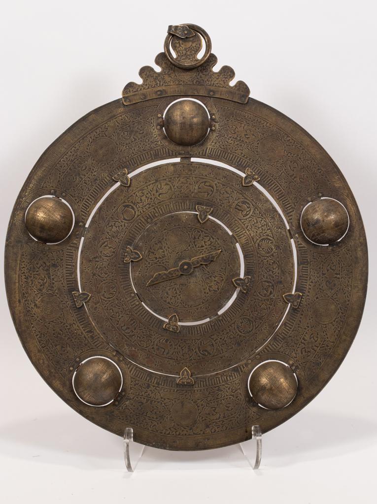 ISLAMIC BRASS ASTROLABE WITH 5 CELESTIAL GLOBES,: ISLAMIC BRASS ASTROLABE WITH 5 CELESTIAL GLOBES, 19TH.C. H 30", DIA 23" An Islamic brass astrological dial. Having etched motifs of constellations, horoscope imagery and repetitive motifs. Double-side