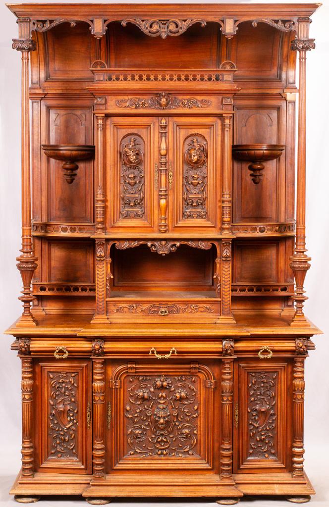 FRENCH RENAISSANCE REVIVAL WALNUT HAND CARVED CABINET: FRENCH RENAISSANCE REVIVAL WALNUT HAND CARVED CABINET C 1850 H 109", W 69", D 24" Made in France. With raised lion heads, hunters' profiles, fruit and floral motif, 3 doors, 3 drawers, an upper cabine