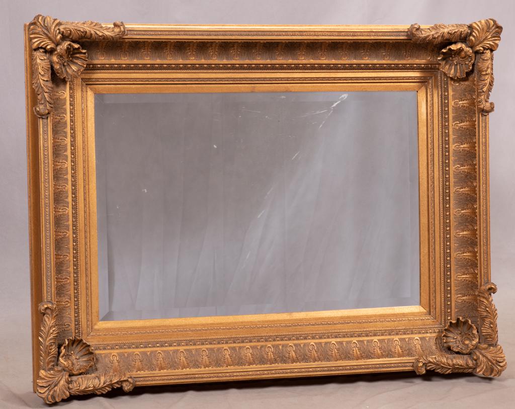 JOHN RICHARD, GILT FRAME WALL MIRROR: JOHN RICHARD, GILT FRAME WALL MIRROR Gesso over wood. Acanthus leaf and flower corners. Label from John Richard, Greenwood, Mississippi.From Rathmor Road, Bloomfield Hills, Mi.