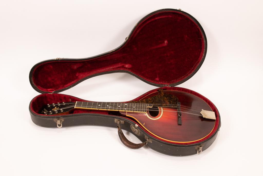 GIBSON "MANDOLA", IN CASE, C 1920 L 28": GIBSON "MANDOLA", IN CASE, C 1920 L 28" Made by Gibson Mandolin-Guitar Co. Kalamazoo, Mi. Mother of pearl and wood inlay. Style H-2. #36683. Black case lined with plush red velvet.