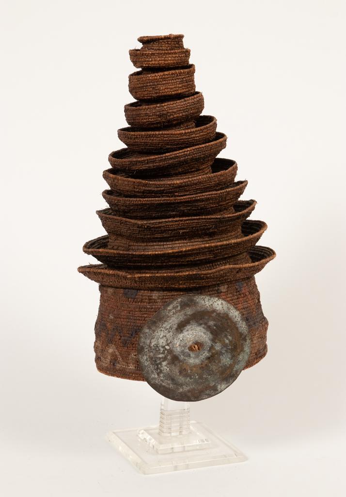 AFRICAN PLANT FIBER, PIGMENT AND A METAL DISC HAT: AFRICAN PLANT FIBER, PIGMENT AND A METAL DISC HAT (ZIGGURAT) H 15" DIA 9" Provenance: Estate of Jack Faxon, Birmingham, MI. Michigan Senator and creator of the Michigan Council for the Arts.
