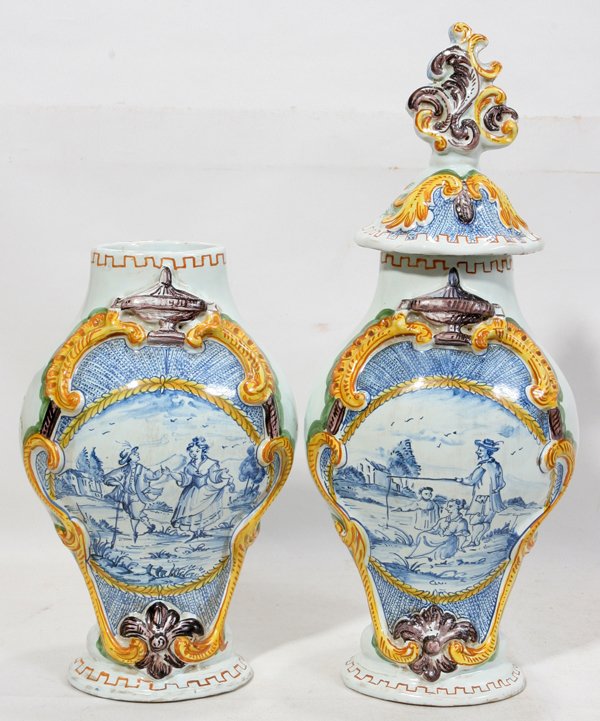 DELFT FAIENCE URNS, 19TH CENTURY, PAIR, H 10": DELFT FAIENCE URNS, 19TH CENTURY, PAIR, H 10", W 6":Each of baluster-form and decorated in blue at one side with figures in landscape settings, within scroll-molded borders of golden yellow, floral sp