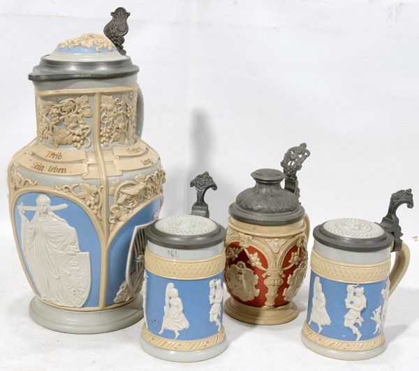 METTLACH RELIEF EWER & STEINS, VILLEROY & BOCH: METTLACH RELIEF EWER & STEINS, VILLEROY & BOCH, EARLY 20TH C., FOUR, H 6"-12":Including 1 ewer and 3 steins (two of which are identical), each features figures in low relief on a medium blue or rusty 