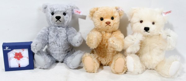 SWAROVSKI CRYSTAL ORNAMENT & STEIFF TEDDY BEARS: SWAROVSKI CRYSTAL ORNAMENT & STEIFF TEDDY BEARS, THREE, H 10":Including 1 Swarovski "Poinsettia" ornament with a Steiff teddy bear, in the original box; 1 Swarovski/Steiff "Alpine White" teddy bear in