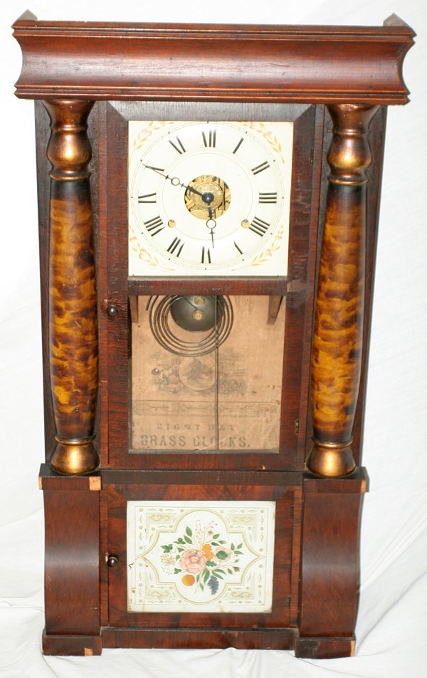 SETH THOMAS ANTIQUE PILLAR CLOCK, C. 1840,: SETH THOMAS ANTIQUE PILLAR CLOCK, C. 1840, H 33', W 18":pillar and scroll. Eight day, hand painted face. Original paper label. Two cast iron weights and one brass pendulum. Two doors. Upper door with