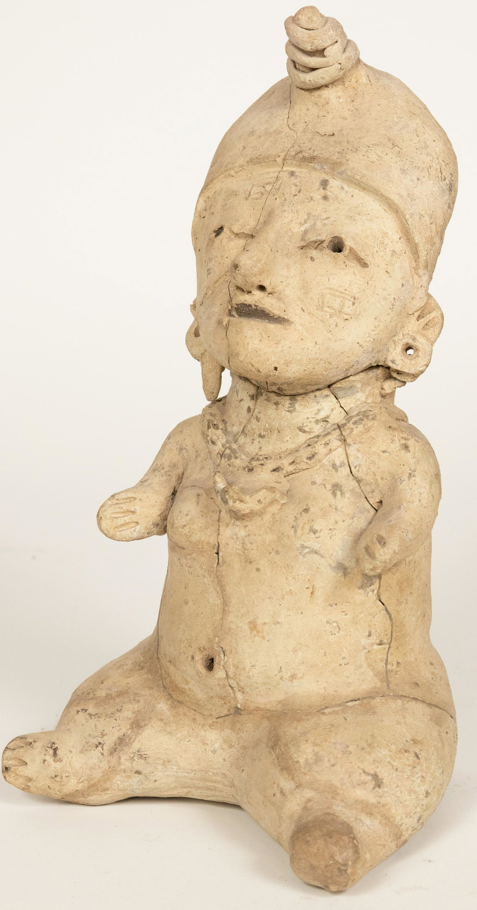 PRE-COLOMBIAN (LIKELY HUAXTEC) EARTHENWARE FIGURAL: PRE-COLOMBIAN (LIKELY HUAXTEC) EARTHENWARE FIGURAL SCULPTURE H 10.5" W 6" D 5" Depicting a shamanesque seated figure. Provenance: Estate of Jack Faxon, Michigan Senator, and creator of the Michigan Co