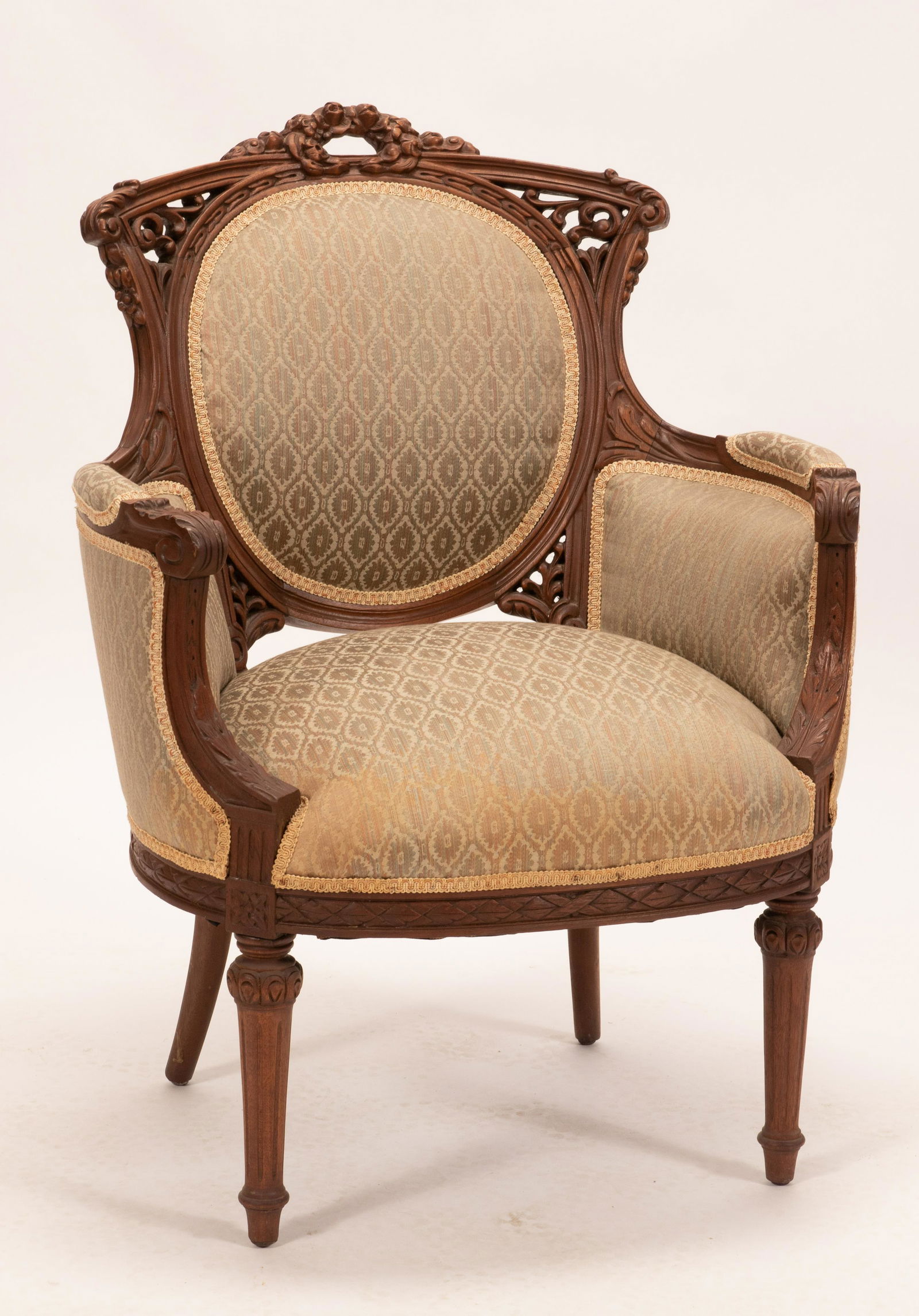 CARVED WALNUT LOUIS XVI STYLE CHAIR C 1930 H 37" W 29": CARVED WALNUT LOUIS XVI STYLE CHAIR C 1930 H 37" W 29" Hand carved frame with wreath at crest,oval back.From the estate of Gloria Anton, Grosse Pointe Shores, Mi.