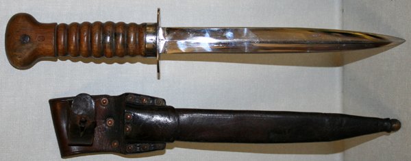 DUTCH WWI MODEL 1917, FIGHTING KNIFE & SCABBARD: DUTCH WWI, MODEL 1917, FIGHTING KNIFE AND SCABBARD, L 8" BLADE:having a plated double edged dagger blade, 8" L. marked with a crown over "Z" inspector stamp with a carved wood handle also with incised