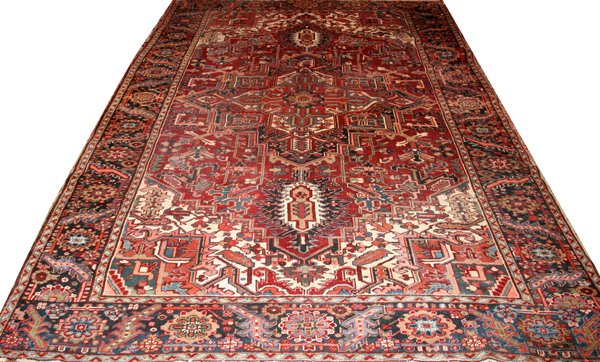 HERIZ PERSIAN RUG, C. 1930, 11' 0" X 8' 0": HERIZ PERSIAN RUG, C. 1930, 11' 0" X 8' 0":Red field with navy border.