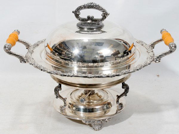 SILVER PLATE CHAFING DISH ON STAND, C. 1940,: SILVER PLATE CHAFING DISH ON STAND, C. 1940, H 12", W 16", D 12":Footed stand and footed bowl. Stand with burner. Five pointed star. Scroll turned Bakelite handles, gadrooned border also flowers and l