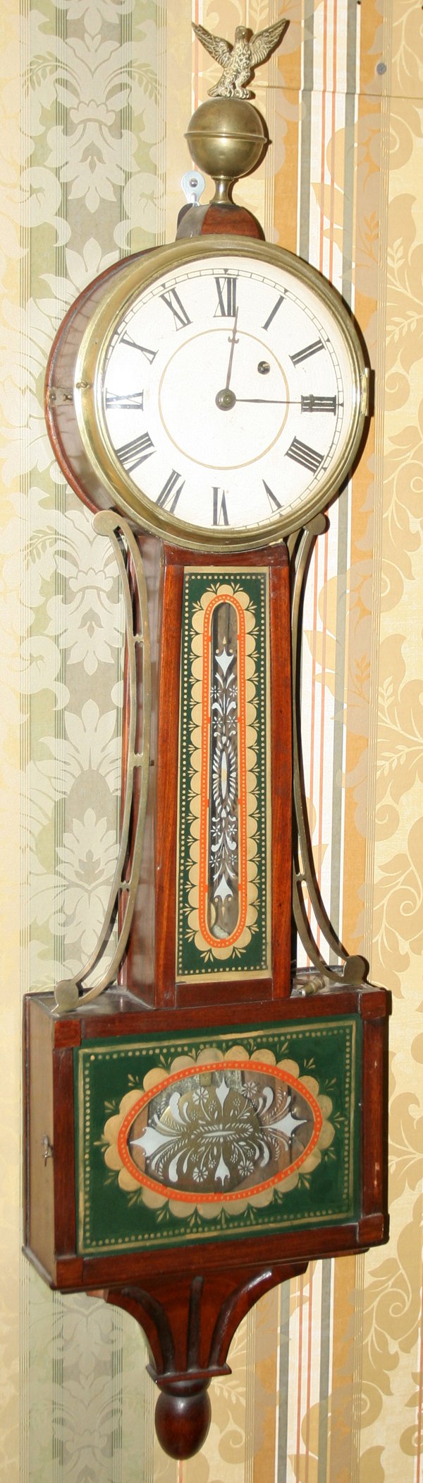 AMERICAN FEDERAL MAHOGANY BANJO CLOCK, C. 1810: AMERICAN FEDERAL MAHOGANY BANJO CLOCK, C. 1810, H 41", W 10", EGLOMISE PANEL:Eglomais glass panels; having a single iron weight and brass pendulum. Brass eagle finial. White painted dial. Brass eagle/