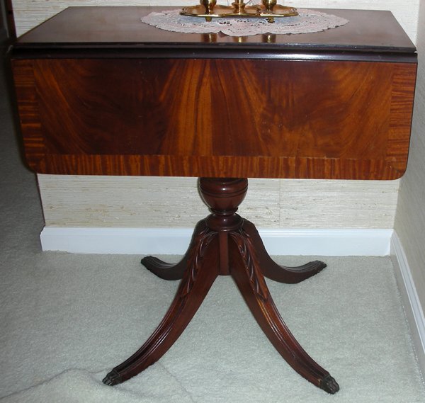 MAHOGANY DROP-LEAF TABLE, H 24", L 23": MAHOGANY DROP-LEAF TABLE, H 24", L 23":Pedestal base. L 23 1/2" W 11" plus two drop leaves each 7".Circa 1950.Made in Grand Rapids. From the Estate of Waldo A. Schaefer, M. D. Port Huron, Mi.
