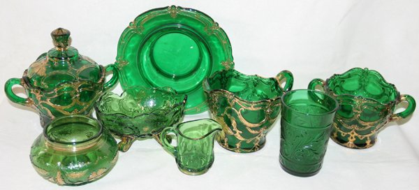 GREEN GLASS TABLE WARE, EIGHT PIECES, C. 1900: GREEN GLASS TABLE WARE, EIGHT PIECES, C. 1900:Including 1 butter dish, Dia7" (no cover), 1 creamer with 1 matching covered sugar bowl and 1 waste bowl, 1 oval footed dish, L.5", 1 powder jar, Dia.3", 