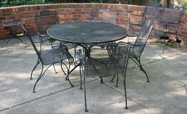 BLACK IRON PATIO FURNITURE, ELEVEN PIECES: BLACK IRON PATIO FURNITURE, ELEVEN PIECES:Including 1 chaise, 1 round table, Dia.48", with 6 chairs, 1 settee, and 2 cocktail tables.