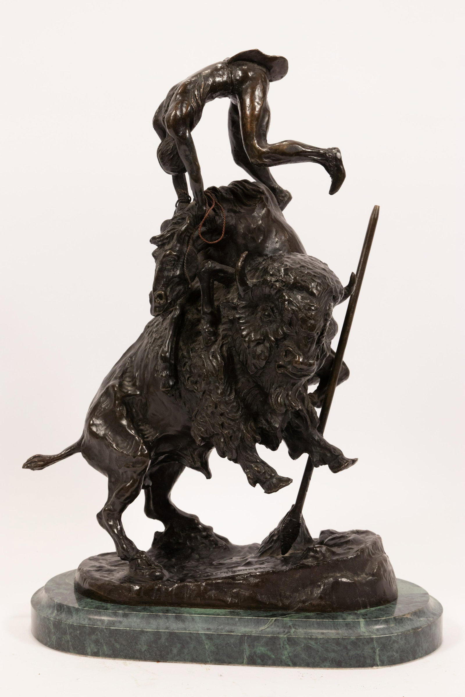AFTER FREDERIC REMINGTON (AMERICAN, 1861-1909) BRONZE: AFTER FREDERIC REMINGTON (AMERICAN, 1861-1909) BRONZE SCULPTURE, H 15", L 9" "THE BUFFALO HORSE" A bronze sculpture after "The Buffalo Horse" (modeled 1907) by Frederic Remington. Presented on a green