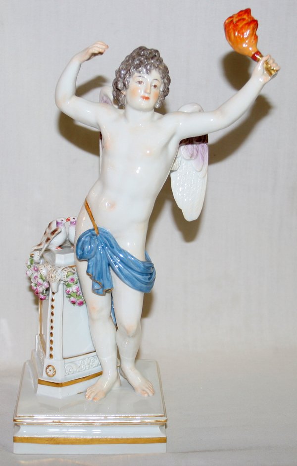 MEISSEN PORCELAIN FIGURE, CUPID WITH TORCH: MEISSEN PORCELAIN FIGURE, CUPID WITH TORCH, C. 1930, H 12":Standing figure of Cupid as a young man holding the torch of love in his left hand, two lovebirds are perched on a pedestal at his side, mark