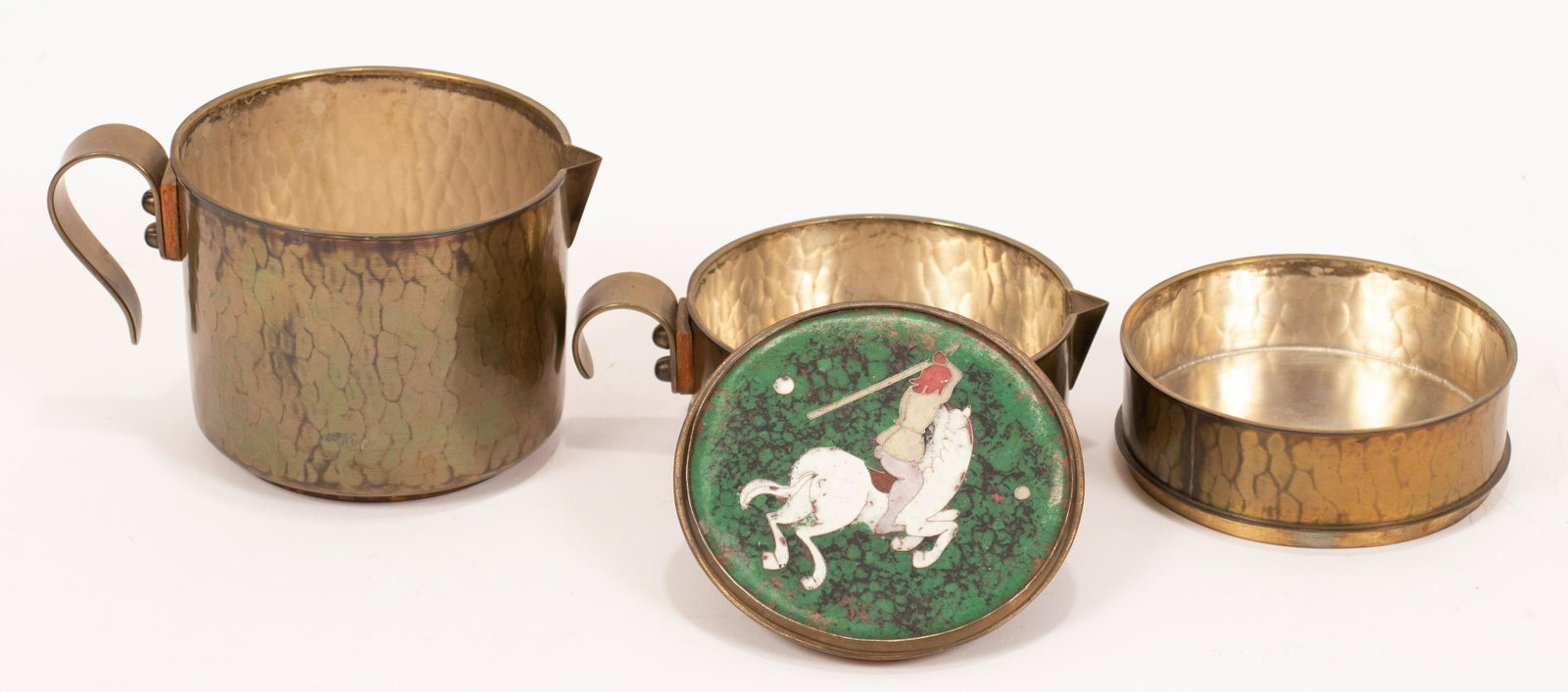 ORIENTAL BRASS & CLOISONNE STACKED TEA SERVICE, H: ORIENTAL BRASS & CLOISONNE STACKED TEA SERVICE, H 5.25", DIA 3.5"An oriental stacked tea service. Comprised of hammered brass and a cloisonne top depicting a polo player. Tiers include a lidded sugar,