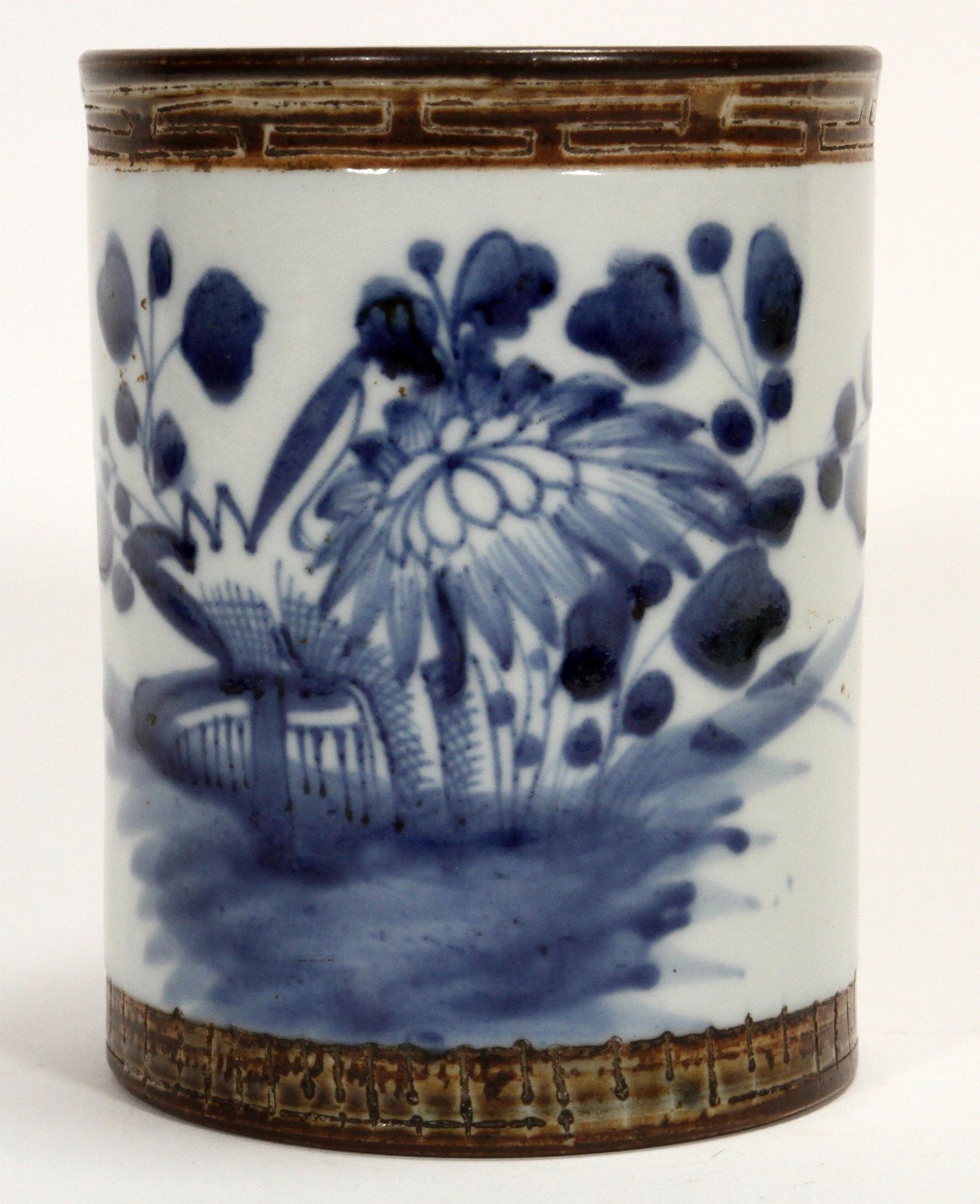 CHINESE HUI STYLE PORCELAIN BRUSH POT H 4.9" DIA 3.85": CHINESE HUI STYLE PORCELAIN BRUSH POT H 4.9" DIA 3.85" Having a Hui style edge augmented with brown glaze and a cobalt floral motif. Underglaze painted hairline cracks on exterior and interior.